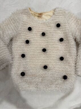 Cozy Cream Fuzzy Crewneck Sweater with Black Pom Pom Accents